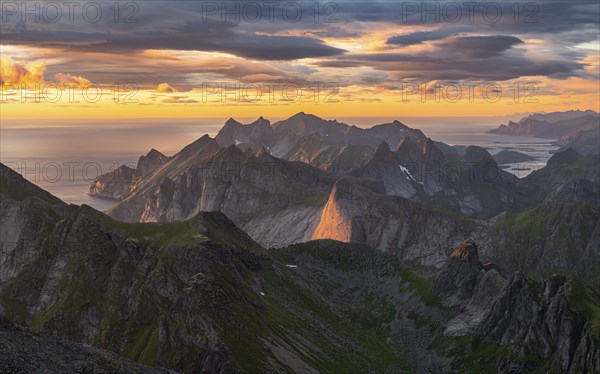 View over mountain top and sea, dramatic sunset, from the top of Hermannsdalstinden, Moskenesöy, Lofoten, Nordland, Norway, Europe