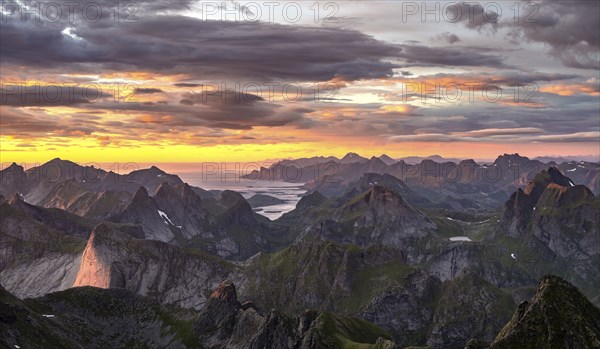 View over mountain top and sea, dramatic sunset, from the top of Hermannsdalstinden, Moskenesöy, Lofoten, Nordland, Norway, Europe