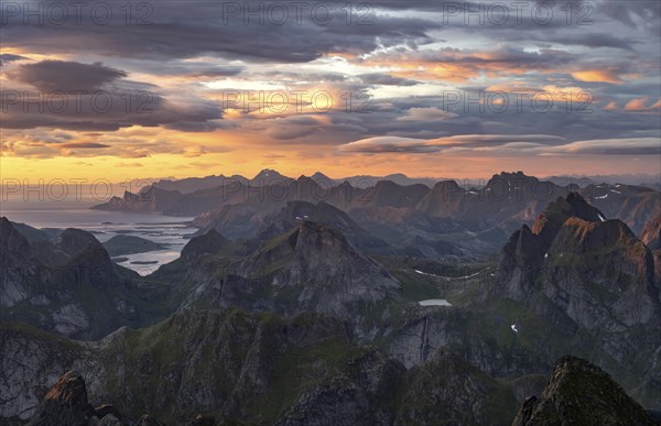 View over mountain top and sea, dramatic sunset, from the top of Hermannsdalstinden, Moskenesöy, Lofoten, Nordland, Norway, Europe