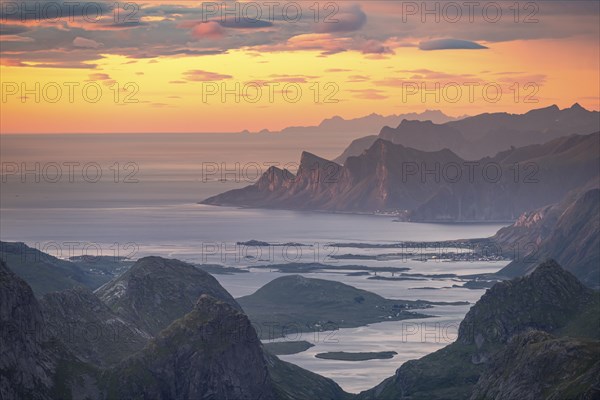 View over mountain top and sea to Fredvang, dramatic sunset, from the top of Hermannsdalstinden, Moskenesöy, Lofoten, Nordland, Norway, Europe