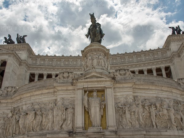 View of a monument decorated with sculptures in Rome under a cloudy sky, rome, italy