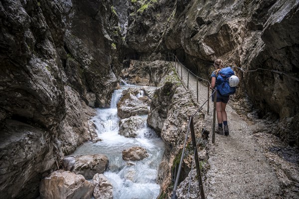Hiker in a gorge, Hammersbach flows through Höllentalklamm, near Garmisch-Partenkirchen, Werdenfelser Land, Upper Bavaria, Bavaria, Germany, Europe