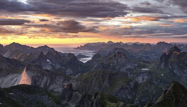 View over mountain top and sea, dramatic sunset, from the top of Hermannsdalstinden, Moskenesöy, Lofoten, Nordland, Norway, Europe