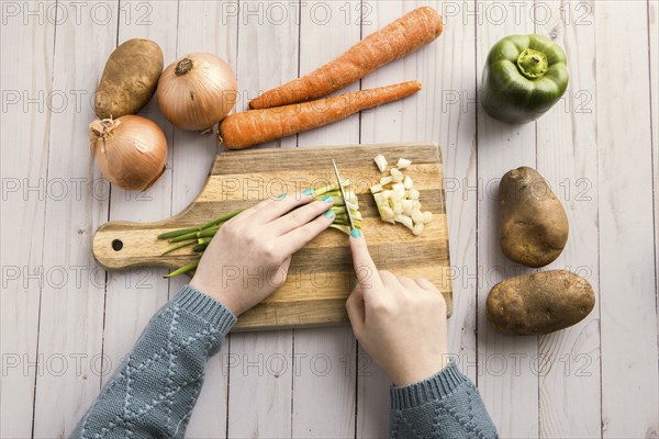 An overhead shot of cutting up assorted vegetables on a cutting board