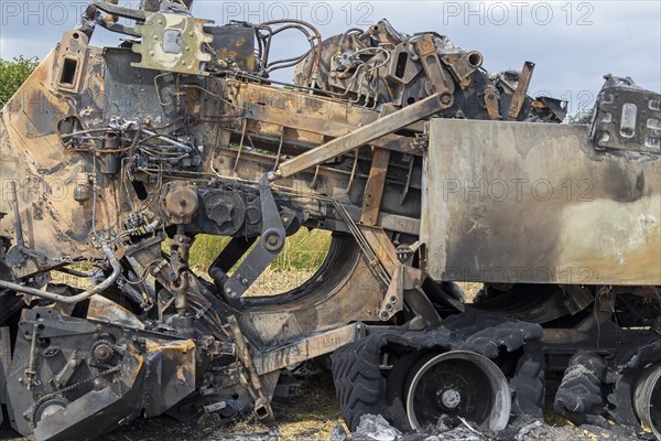 Burnt-out combine harvester, Steinbergkirche, Schleswig-Holstein, Germany, Europe