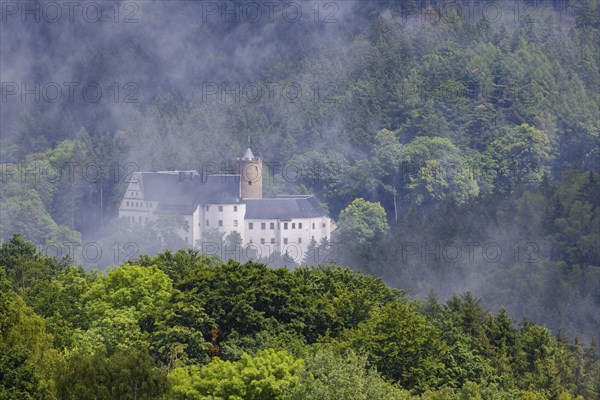 Scharfenstein Castle seen through the rain and fog