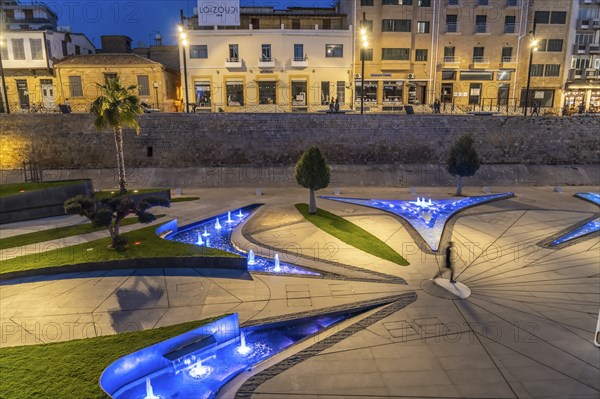 Modern architecture and colourfully lit fountains of Eleftheria Square at dusk, Nicosia, Cyprus, Europe