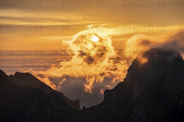 Sunrise, sun shining over mountains in fog, Säntis, Appenzell Ausserrhoden, Appenzell Alps, Switzerland, Europe