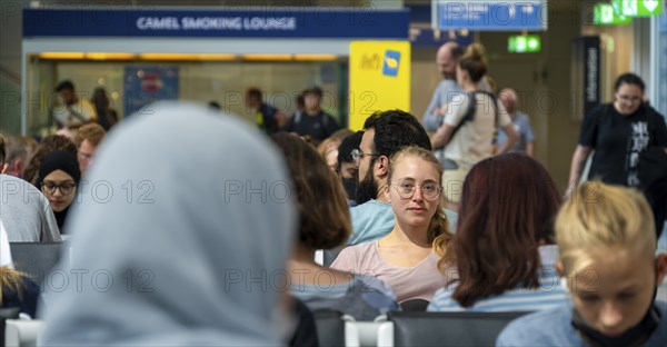 Waiting hall, Young woman waiting for her departure, Check-in, Munich Airport, Bavaria, Germany, Europe