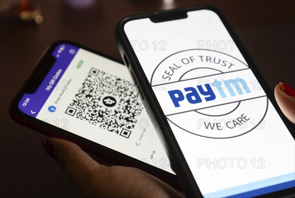 In this photo illustration, the Paytm logo and PhonePe QR code, is seen displayed on mobile phones screen in Guwanati, India on 19 July 2023.