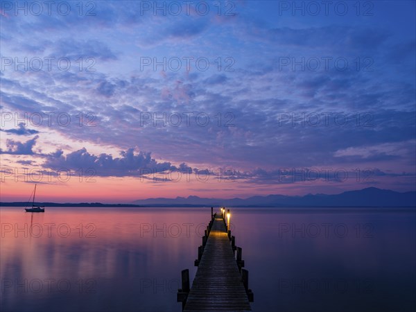 Sailing boat and jetty on Lake Chiemsee at dawn, behind the Chiemgau Alps, Chiemgau, Upper Bavaria, Bavaria, Germany, Europe