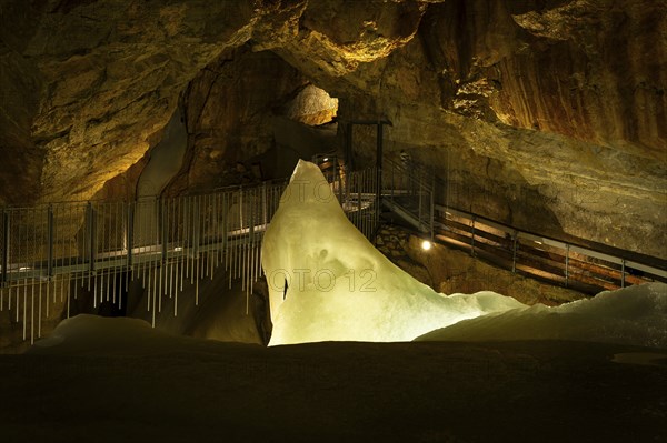 The illuminated Giant Ice Cave, a cave in the Dachstein massif. The suspension bridge in Tristandom. Obertraun, Salzkammergut, Upper Austria, Austria, Europe