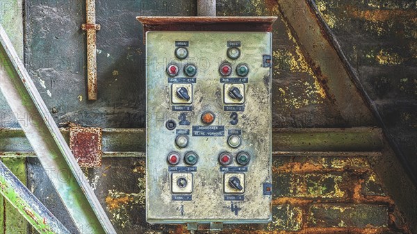 A rusty old switch box with several buttons and switches in a wall-mounted industrial environment, Metallwerke Bender, Lost Place, Linn, Krefeld, North Rhine-Westphalia, Germany, Europe
