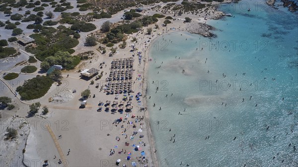 Overtourism, aerial view of a beach with people and umbrellas and a roof area next to the water, Elafonissi, lagoon, south-west tip of Crete, Crete, Greek Islands, Greece, Europe