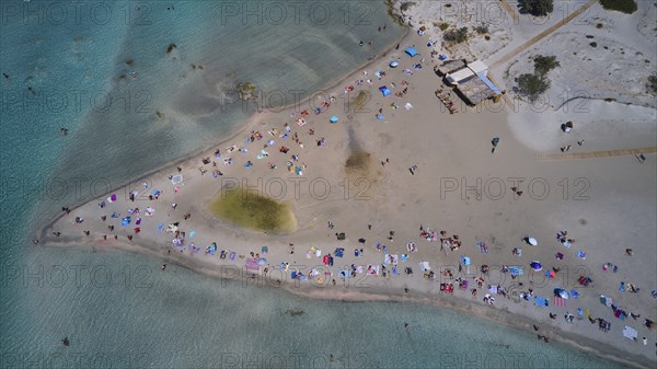Overtourism, aerial view of a beach with many people and colourful umbrellas enjoying the sand and the sea, Elafonissi, lagoon, southwestern tip of Crete, Crete, Greek Islands, Greece, Europe