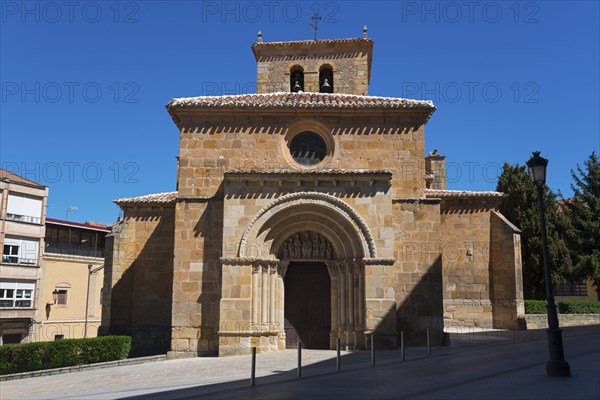 Romanesque church with stone façade and tower under a clear blue sky, surrounded by buildings, Church of San Juan de Rabanera, Soria, Castilla y León, Leon, Spain, Europe