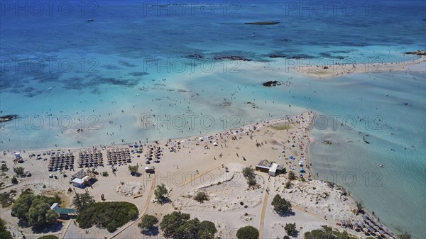 Overtourism, aerial view of a beach with people and umbrellas surrounded by blue sea water, Elafonissi, lagoon, south-west tip of Crete, Crete, Greek Islands, Greece, Europe
