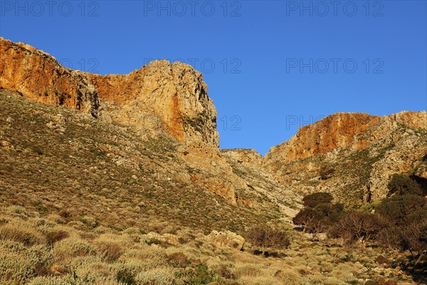 Morning light, Sunny landscape of vegetation-rich hills and rocks under a clear blue sky, Gramvoussa peninsula, north-west Crete, Crete, Greek Islands, Greece, Europe