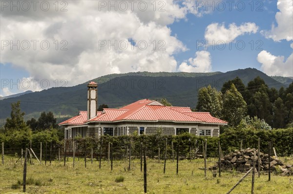 Modern residential house in Africa with a fence. Accommodation in Kenya. Magnificent cityscape