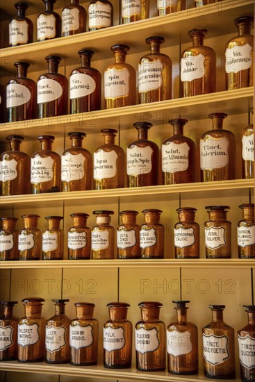 Enkhuizen, Netherlands, June 2022. Shelves with glass jars containing ingredients for medicine. Close up. Selective focus