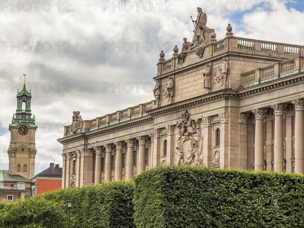 Majestic historical building with decorations and statues on a slightly cloudy sky background, stockholm, baltic sea, sweden, scandinavia