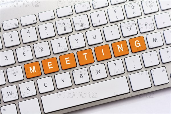 MEETING writing on white keyboard