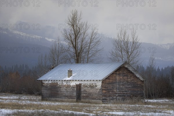 An old shed stands in a lightly snow covered field in north Idaho