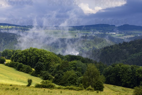 Scharfenstein Castle seen through the rain and fog