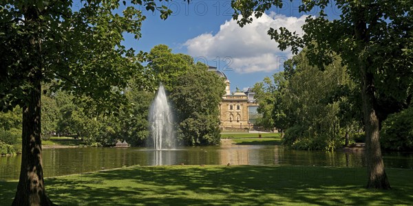 Fountain in the pond, Warmer Damm Landscape Park with Hessian State Theatre, Wiesbaden, Hesse, Germany, Europe