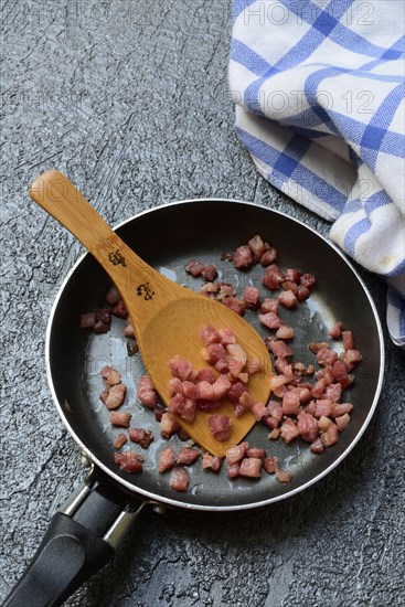 Fried bacon cubes in pan, bacon