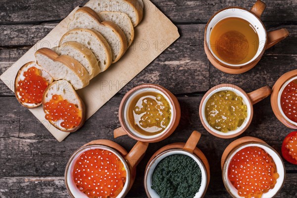 Different kinds of caviar with bread and beverages, AI generated