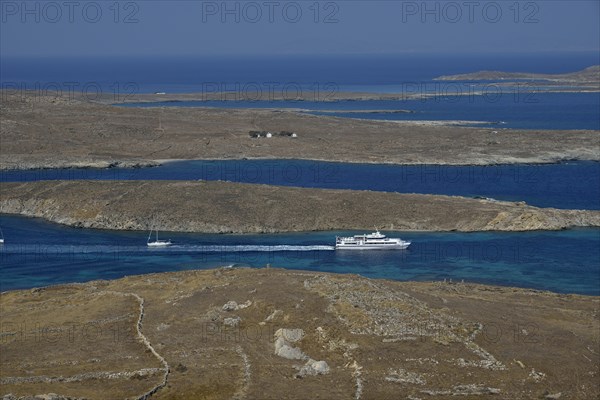 View over the island of Delos with an excursion boat, Cyclades, Greece, Europe