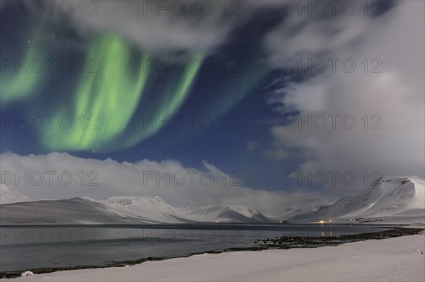 Northern Lights over fjord landscape, Aurora borealis, snow, winter, mountains, Thingeyri, Westfjords, Iceland, Europe