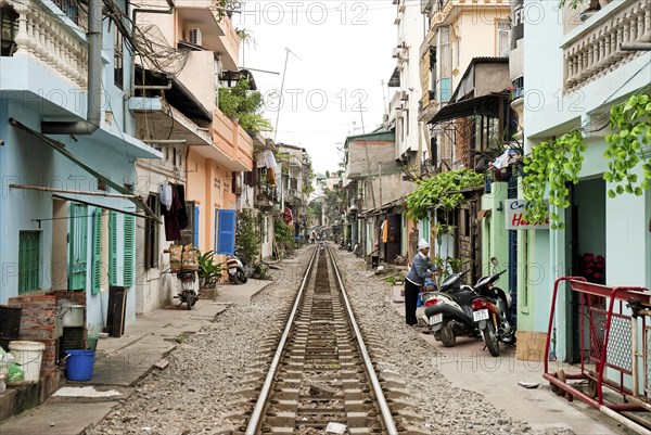 Asian travel tourism holidays vacations tourist east orient oriental modern railway poverty housing shanty town poor asia vietnam vietnamese