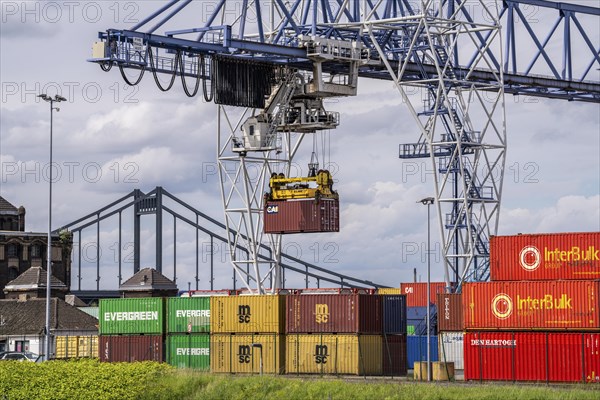 Container terminal at the Rhine port of Krefeld, inland port, 4th largest public port in North Rhine-Westphalia, trimodal handling of goods, goods, containers, general cargo, in the background the Krefeld-Uerdingen bridge over the Rhine, North Rhine-Westphalia, Germany, Europe