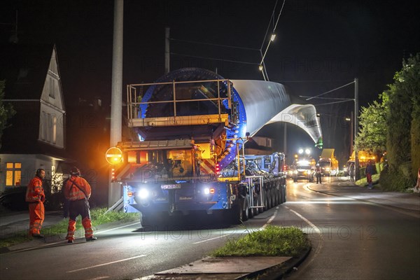 Transport of a 68 metre long, 22 tonne blade of a wind turbine, here in Schwelm, with a self-propelled Blade-Lifter vehicle, over a 40 km long route, over 2 nights, in the Bergisches Land, through towns, villages, over country roads, narrow through roads, to the construction site of the wind turbine near Hagen, North Rhine-Westphalia, Germany, Europe