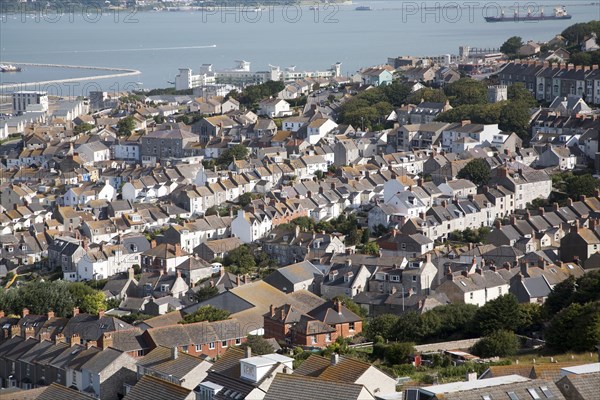 High density housing in Fortuneswell, Isle of Portland, Dorset, England with Weymouth harbour in the background