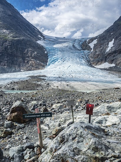 Glacier Steindalsbreen, glacier tongue, signpost and 'trimkassa' at end of valley Steindalen, Lyngen alps, south of Lyngseidet, Troms county, Norway, Europe
