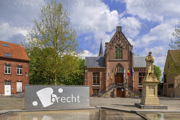 Former city hall in neo-Gothic style and statue of Gabriel Mudaeus on the town square in the municipality Brecht, Antwerp Province, Flanders, Belgium, Europe