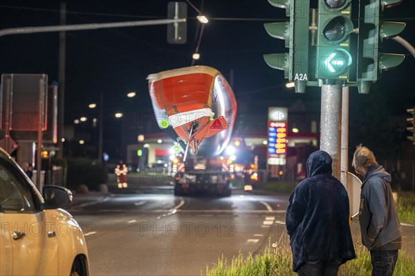 Transport of a 68 metre long, 22 tonne blade of a wind turbine, here in Schwelm, with a self-propelled Blade-Lifter vehicle, over a 40 km long route, over 2 nights, in the Bergisches Land, through towns, villages, over country roads, narrow through roads, to the construction site of the wind turbine near Hagen, North Rhine-Westphalia, Germany, Europe