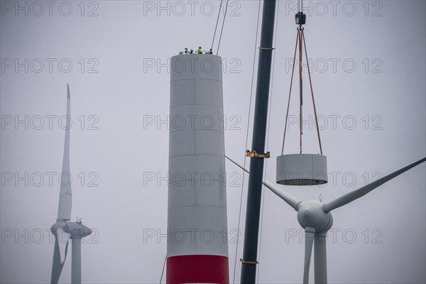 Construction of the tower of a wind power plant in a wind farm near Issum, 9 older wind turbines from the manufacturer Enercon (model series E-58) at the rear right, which have been in operation for over two decades, will be replaced by a total of four Enercon E-160 turbines, under construction, with a total output of 22 megawatts, Lower Rhine, North Rhine-Westphalia, Germany, Europe