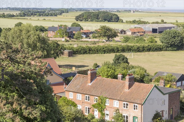 North Sea village landscape over fields in summer at Bawdsey, Suffolk, England, UK view from church tower