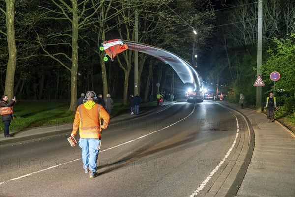 Transport of a 68 metre long, 22 tonne blade of a wind turbine, here in Schwelm, with a self-propelled Blade-Lifter vehicle, over a 40 km long route, over 2 nights, in the Bergisches Land, through towns, villages, over country roads, narrow through roads, to the construction site of the wind turbine near Hagen, North Rhine-Westphalia, Germany, Europe