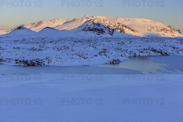 Morning light on a snowy lava field, lake, volcanic crater, snow, winter, Berserkjahraun, Snaefellsnes, Vesturland, Iceland, Europe