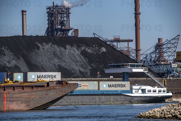 ThyssenKrupp steelworks in Duisburg-Marxloh, blast furnace Schwelgern 2, coal store of the Schwelgern coking plant, cargo ship on the Rhine, Duisburg, North Rhine-Westphalia, Germany, Europe