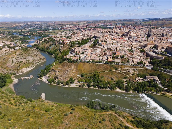 Panoramic view of a city with a river and several bridges, surrounded by hills and many houses, aerial view, Toledo, Tagus River, Castilla-La Mancha, Spain, Europe