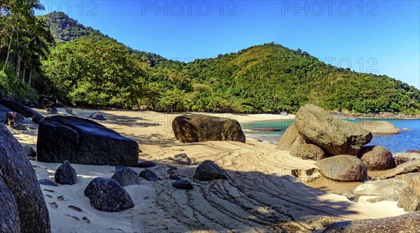Forest, hill, rocks and sea of stunning Indaiauba beach in Ilhabela island coast os Sao Paulo, Indaiauba beach, Ilhabela, Sao Paulo, Brazil, South America