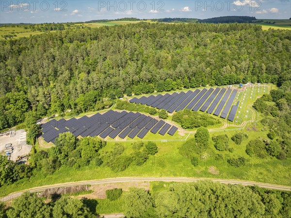 Aerial view of a large solar panel farm, surrounded by forest and fields, construction of the Black Forest Nature solar park, Weil der Stadt, Germany, Europe