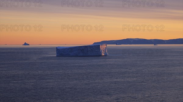 Iceberg seen from cruise ship vacation near Greenland coast in Arctic circle near Ilulissat Disko Bay