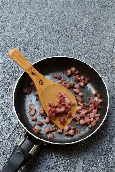 Fried bacon cubes in pan, bacon